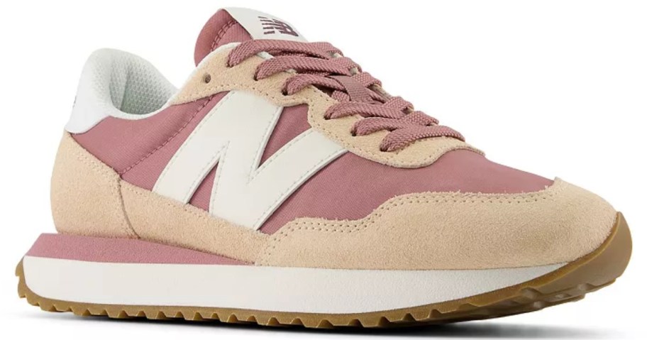 a women's New Balance sneaker in pink, light peachish tan and white