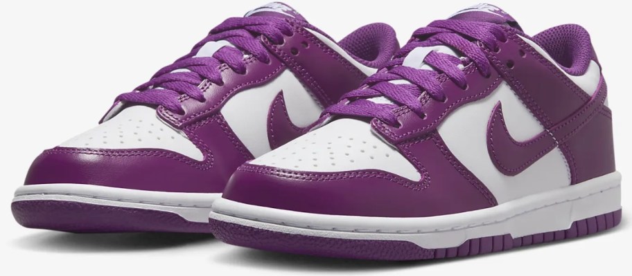 a pair of kid's Nike Dunk style shoes in white and purple