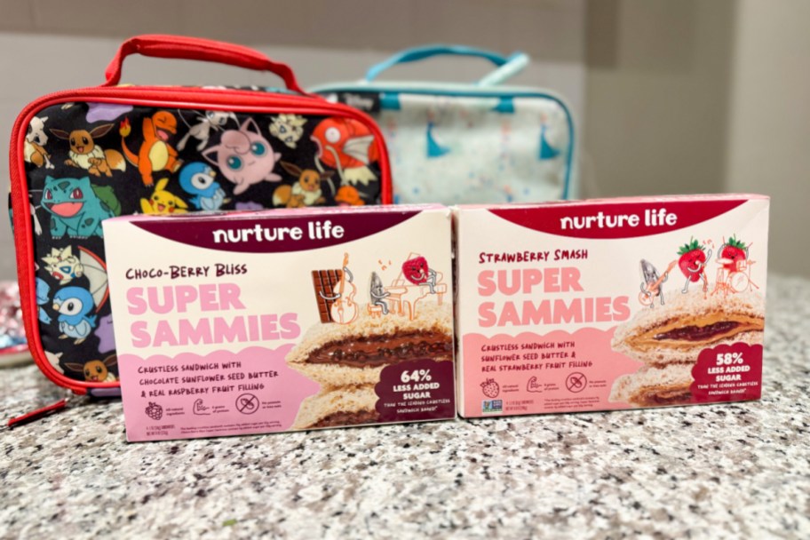 two crustless sandwich boxes next to two lunchboxes