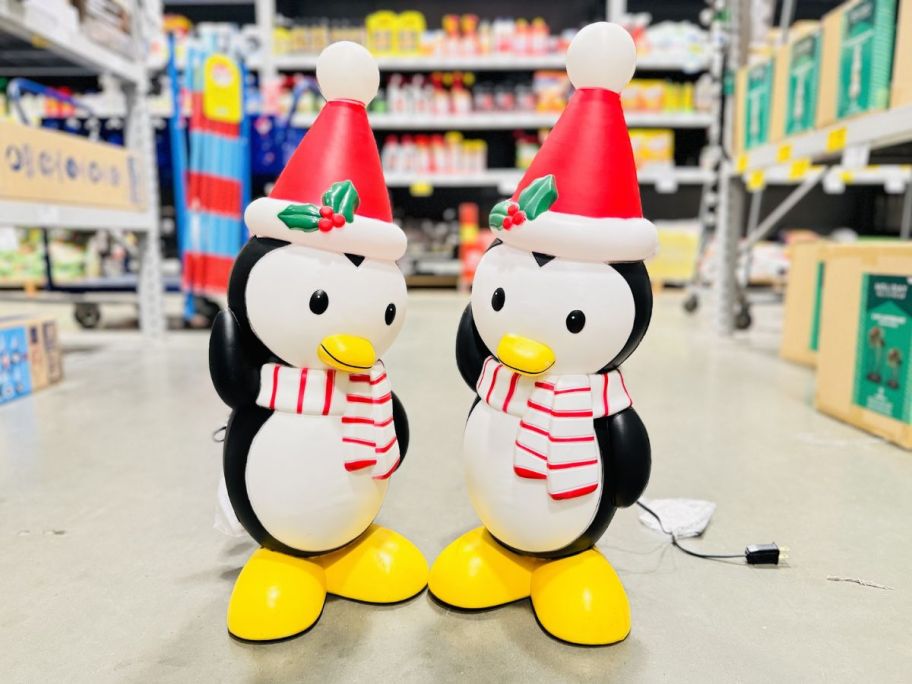 two penguin blow molds on a store aisle