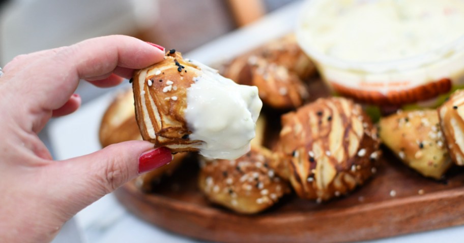 pretzel bite dipped in cheese 