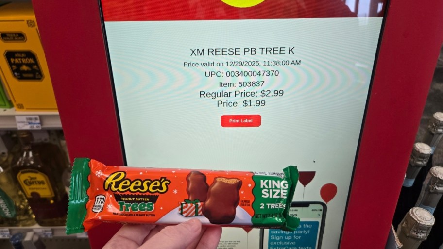 womans hand holding pack of reeses trees