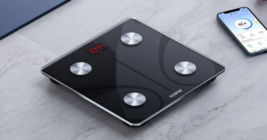 black scale on ground with phone