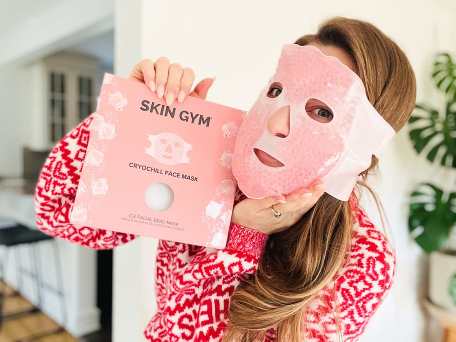 women holding box while wearing pink ice pack face mask