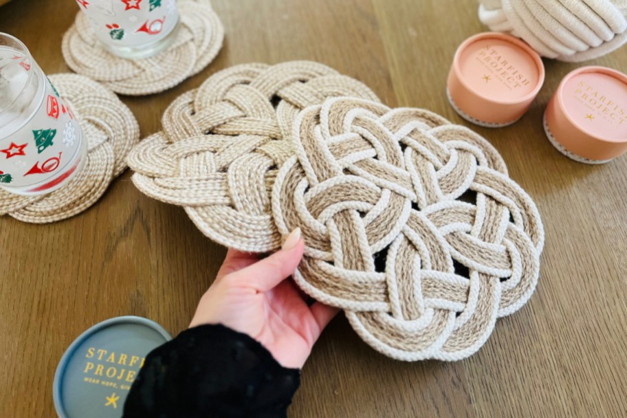hand holding jute braided trivets