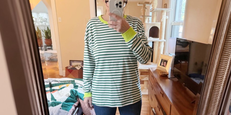 Woman wearing white and green long sleeve striped t-shirt 