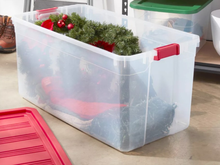 large clear bin with wreaths inside