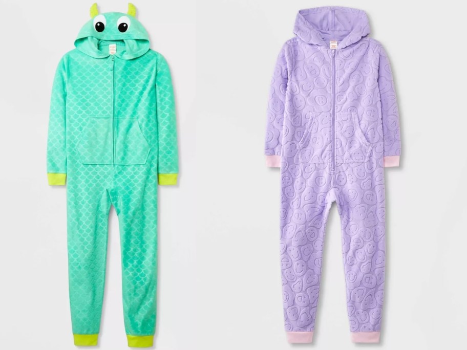 kids one piece union suit hooded pajamas, one is green with a dragon eyes and scales on the hood and back and one is purple with smiley faces embossed on it