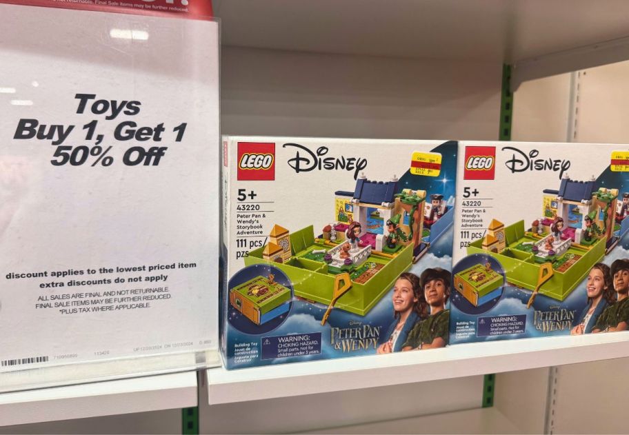 macys instore toy bogo sign next to 2 lego sets on a store shelf