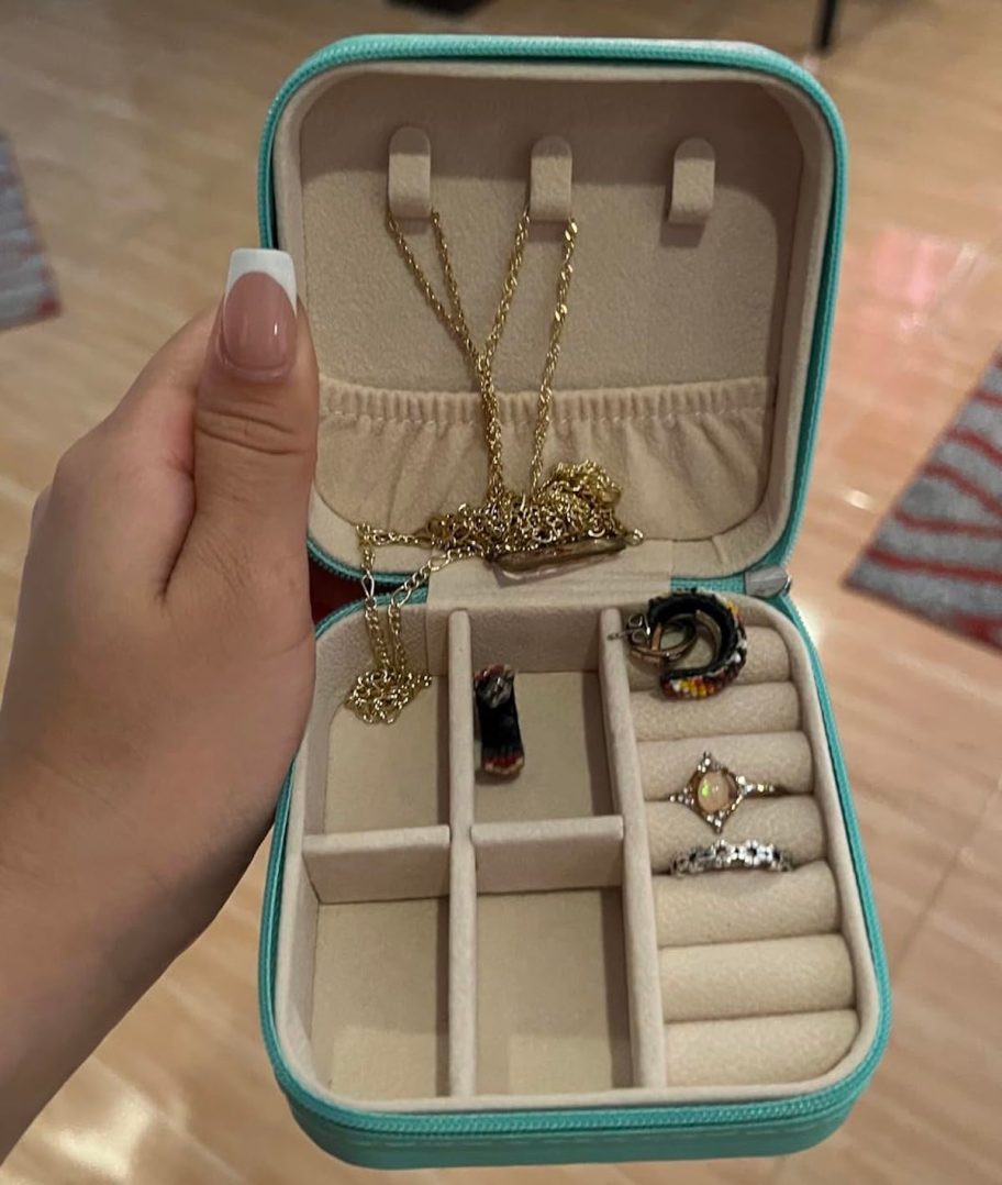 hand holding travel sized jewelry case