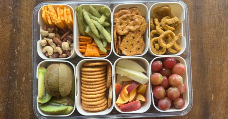 divided serving tray with snacks in it on table