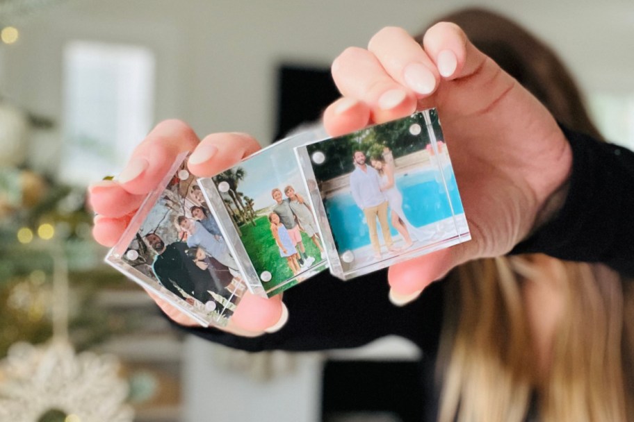 Woman holding three acrylic photo blocks in front of her face