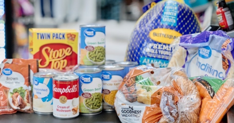 Thanksgiving dinner items including a Butterball turkey, canned food, rolls, Stove Top Stuffing, potatoes and more on a counter