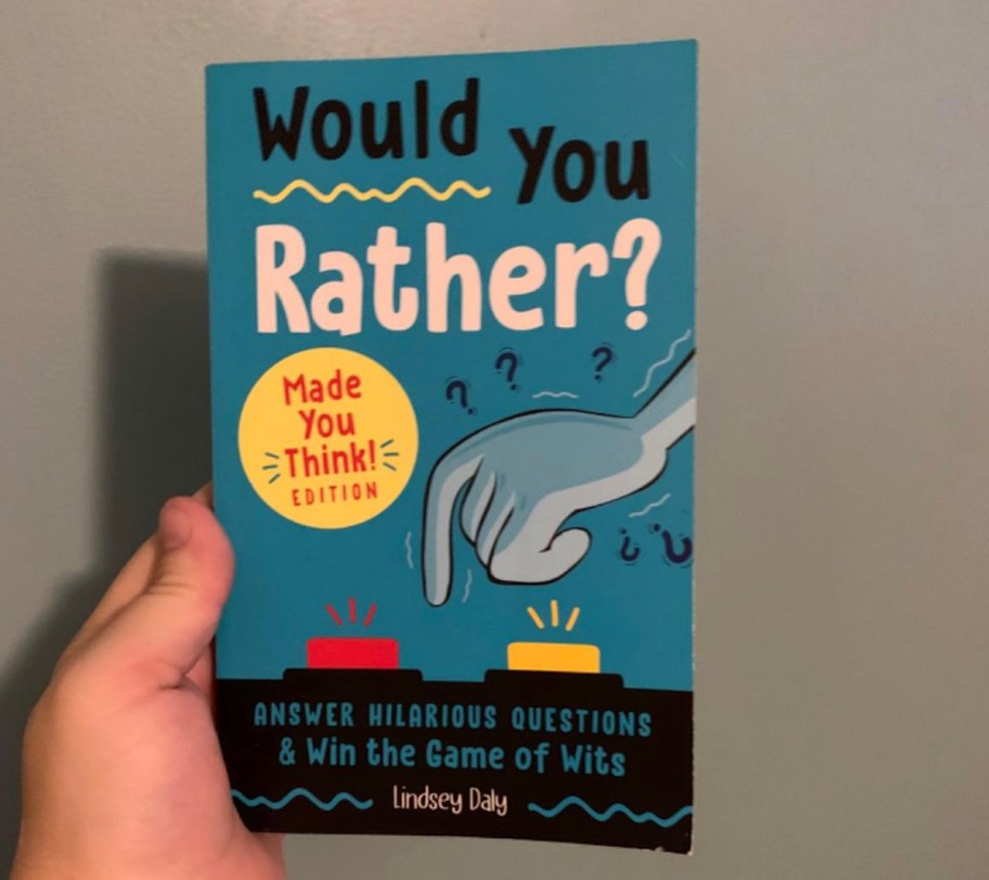 Hand holding a would you rather book