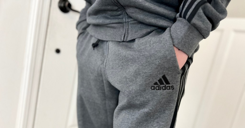 Boy wearing gray, Adidas sweats and a hoodie