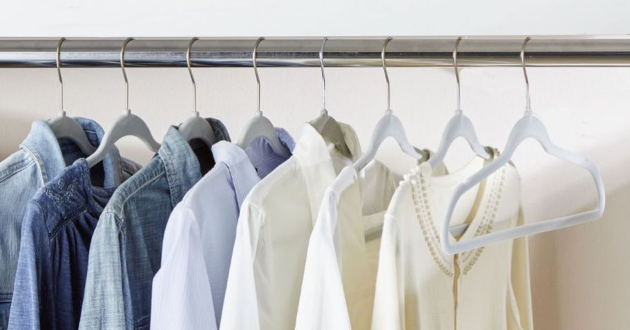 silver velvet hangers on rack in closet holding clothing