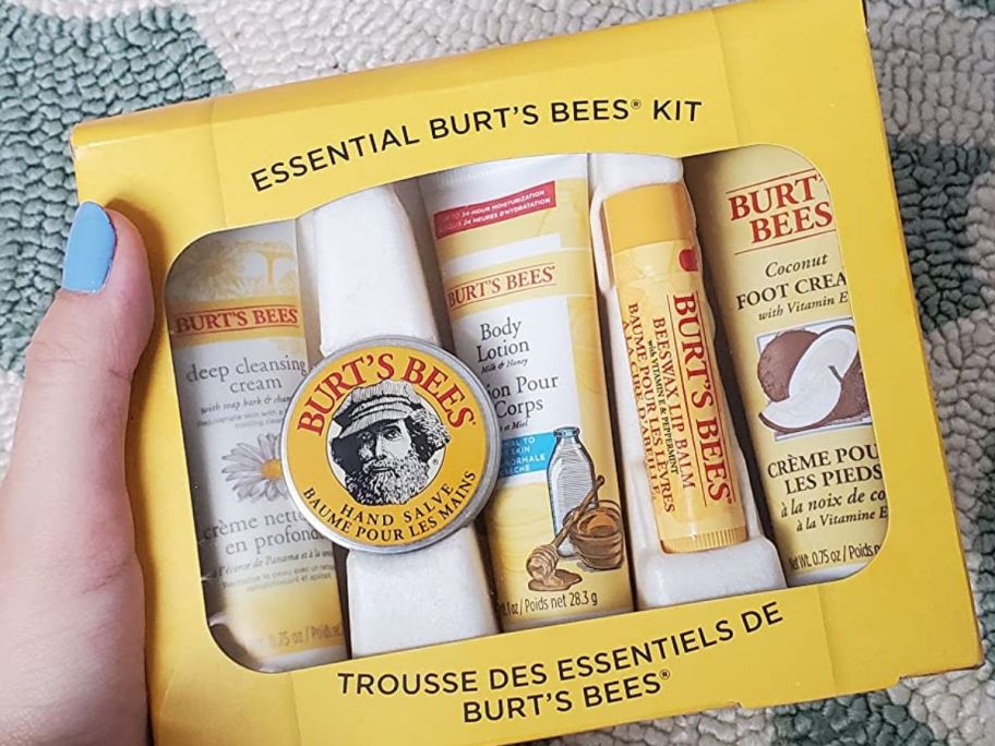 hand holding Burts bees essentials set