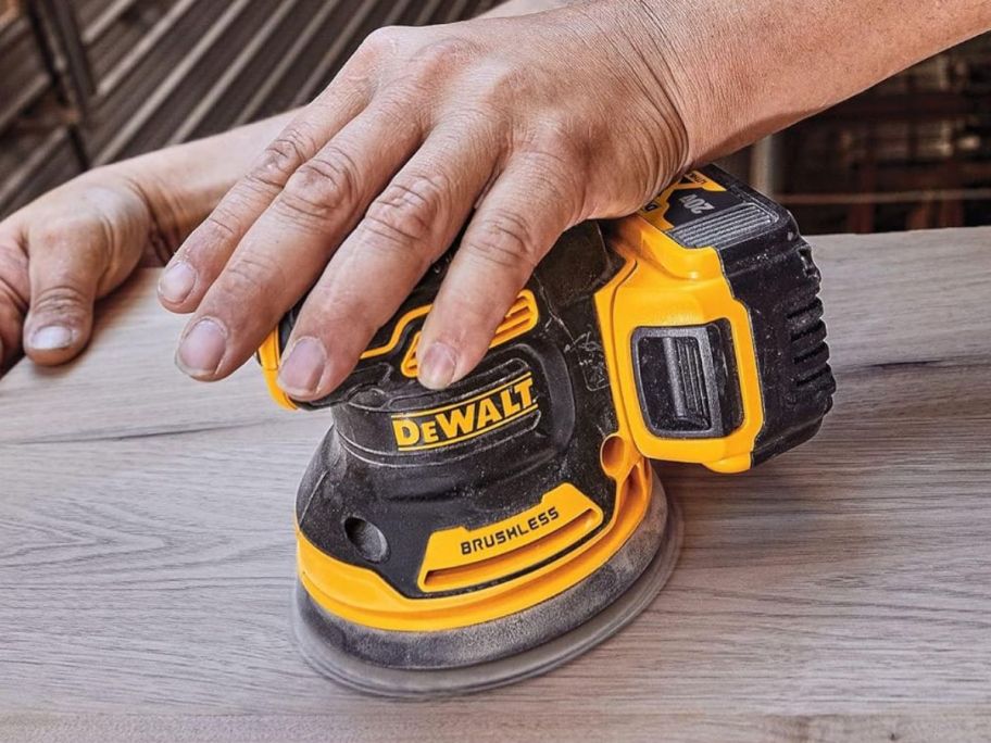 person using DeWalt 20V Max Orbital Sander