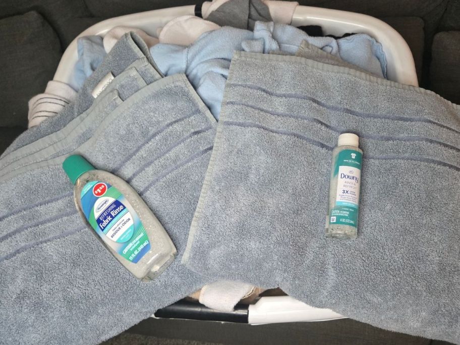 gray towels with a bottle of Dollar Tree Fabric Rinse and a Downy Rinse & Refresh