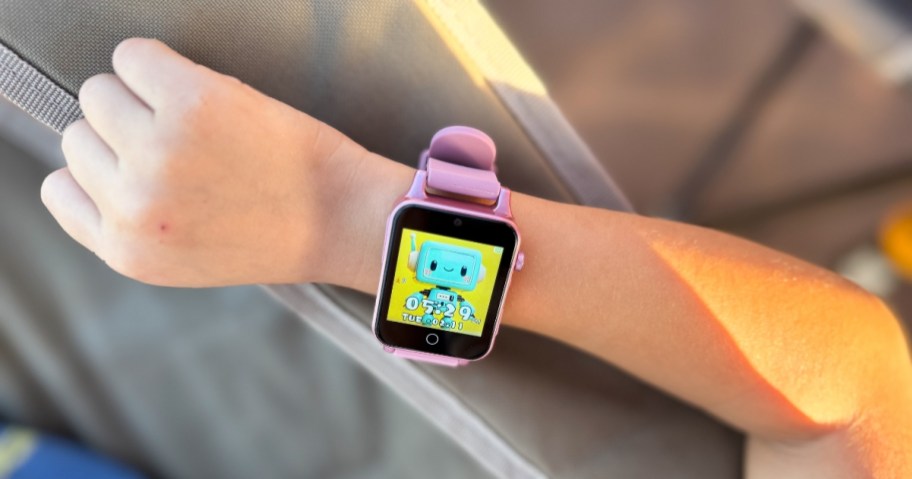 a pink kids smartwatch on a kids wrist