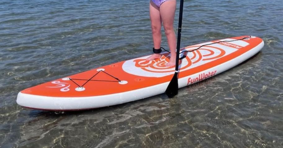 girl standing on Inflatable Paddle Board - Orange Dragon Totem