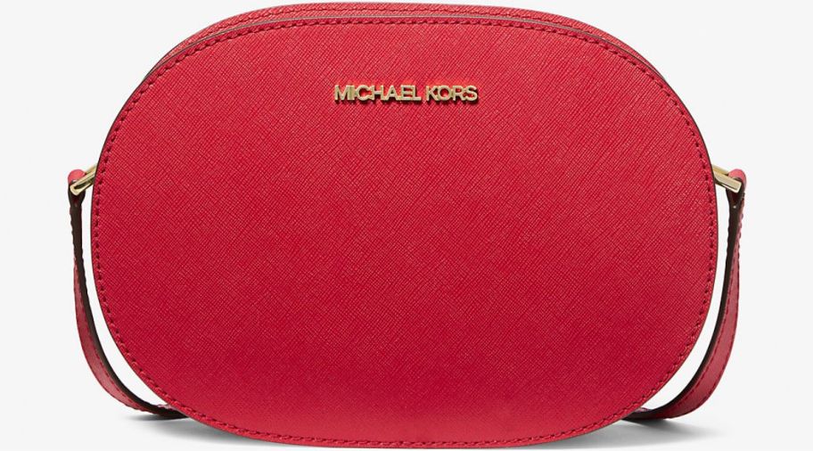 a medium red oval shaped crossbody handbag with a leather strap