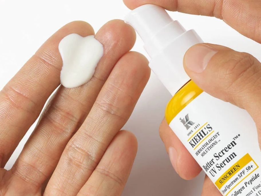 Hand pumping. Kiehl's Better Screen UV Serum SPF 50+ onto another hand
