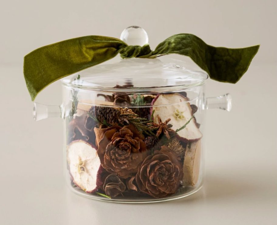 A glass pot filled with dried simmering botanicals
