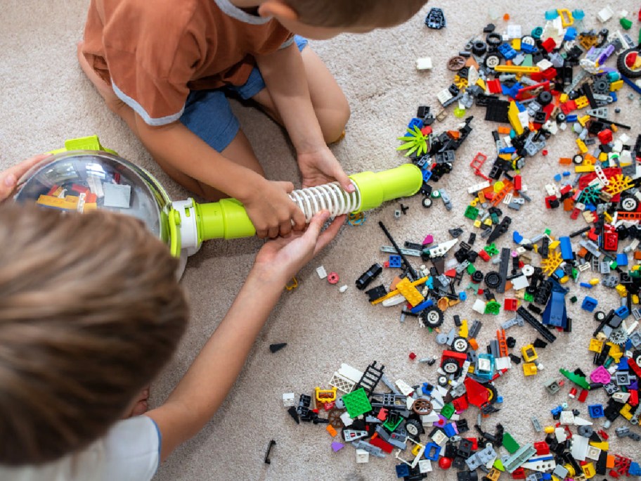 boys using a Pick-Up Bricks Vacuum to clean up LEGOs