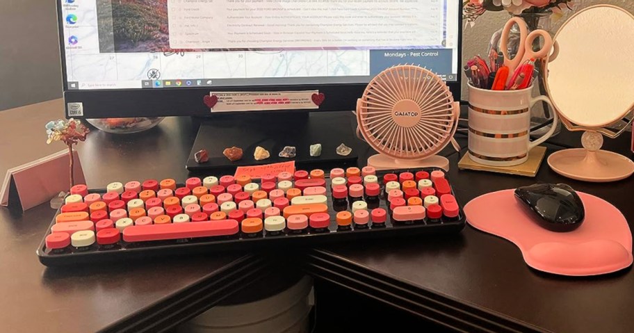 red and black keyboard and mouse on computer desk 