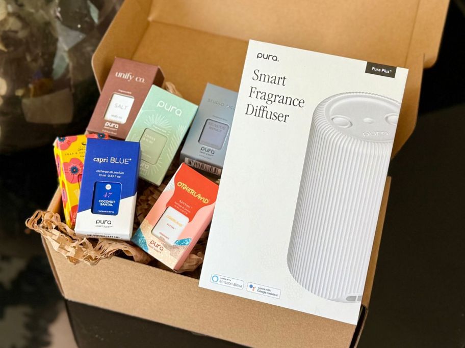 A Pura Smart Diffuser with several refills