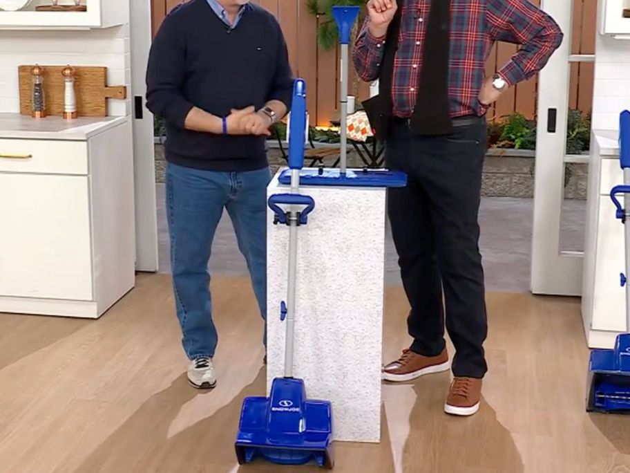 Two men standing with a Snow Joe Snow Thrower and Foam Broom Set