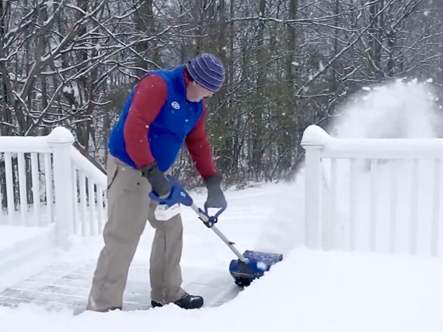 Man clearing a deck with a Snow Joe Electric Snow Thrower Shovel