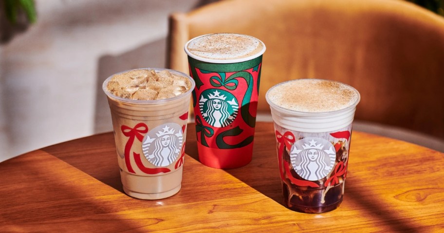 starbucks eggnog latte and chestnut praline lattes in holiday cups on table