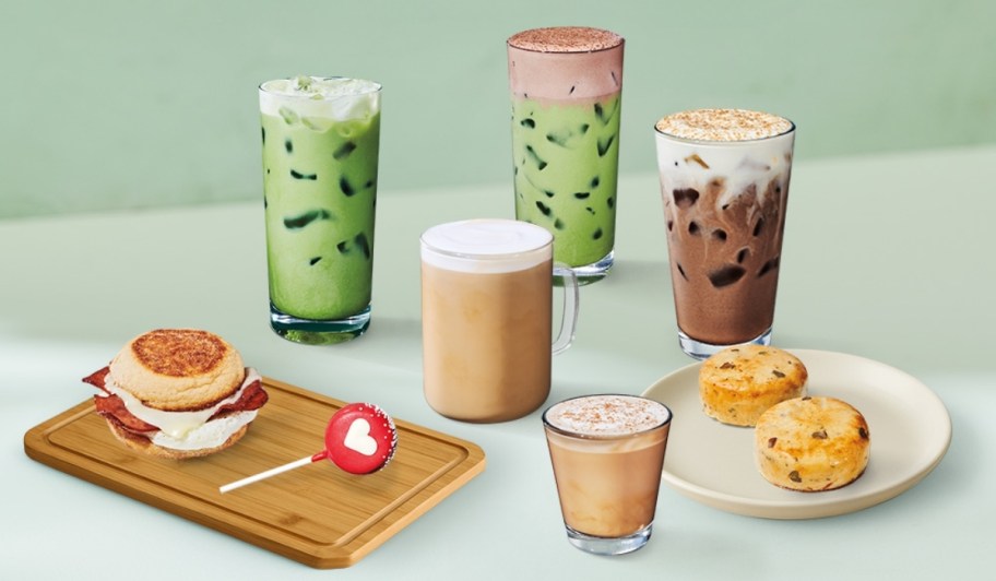 starbucks 2026 winter menu lattes, matchas, and cold brews with sandwich, cake pop and egg bites on table