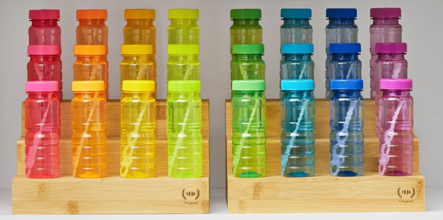 colorful bottles of bubbles displayed on bamboo risers