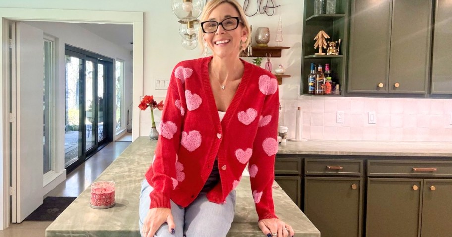 woman wearing valentine's day heart cardigan in red