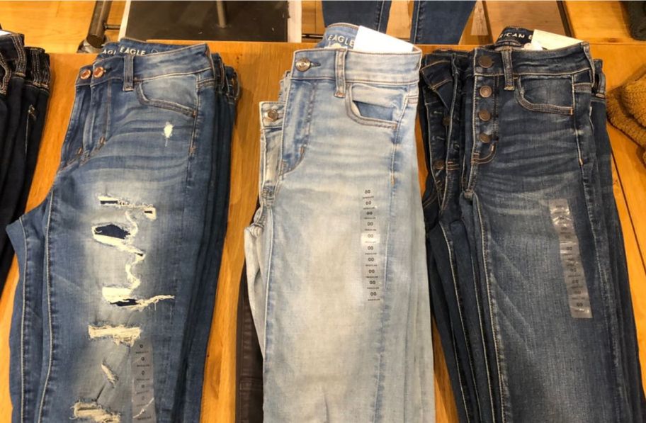 3 pairs of american eagle jeans on display table oa store