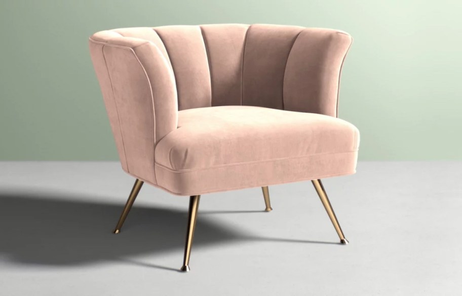 light pink tulip chair on plain gray floor with sage green walls