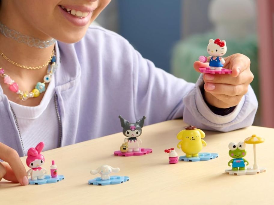 kid playing with BLDR Hello Kitty & Friends Minifigures 6-Pack on table
