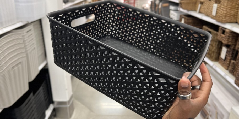 hand holding black storage bin