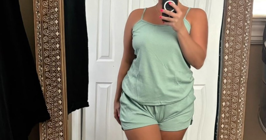 woman in green pajamas taking selfie