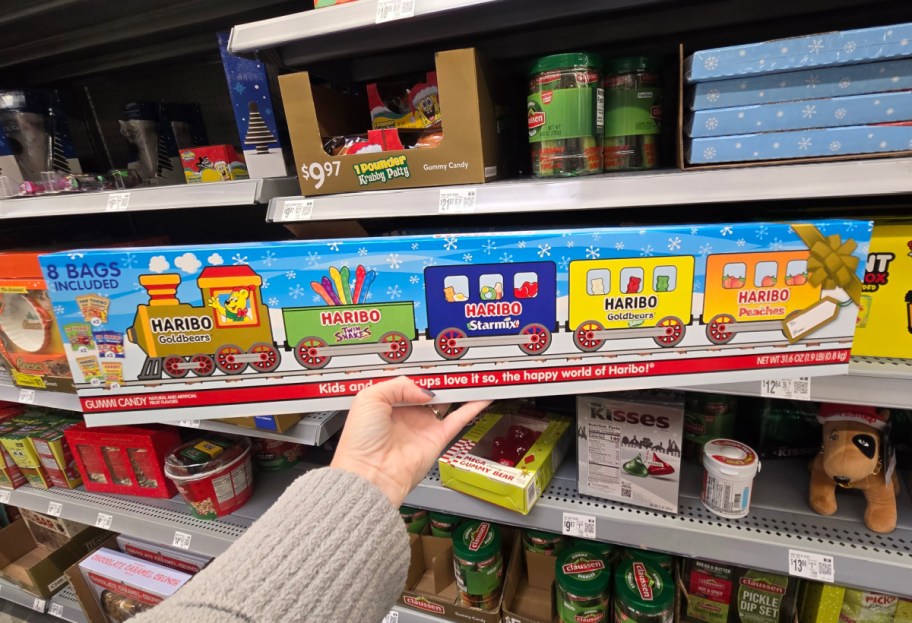 A hand holding up a giant pack of Haribo candy.