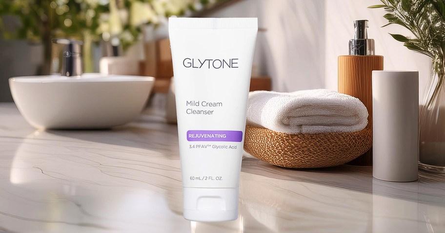 Tube of Glytone Skin Cleanser on a bathroom counter.