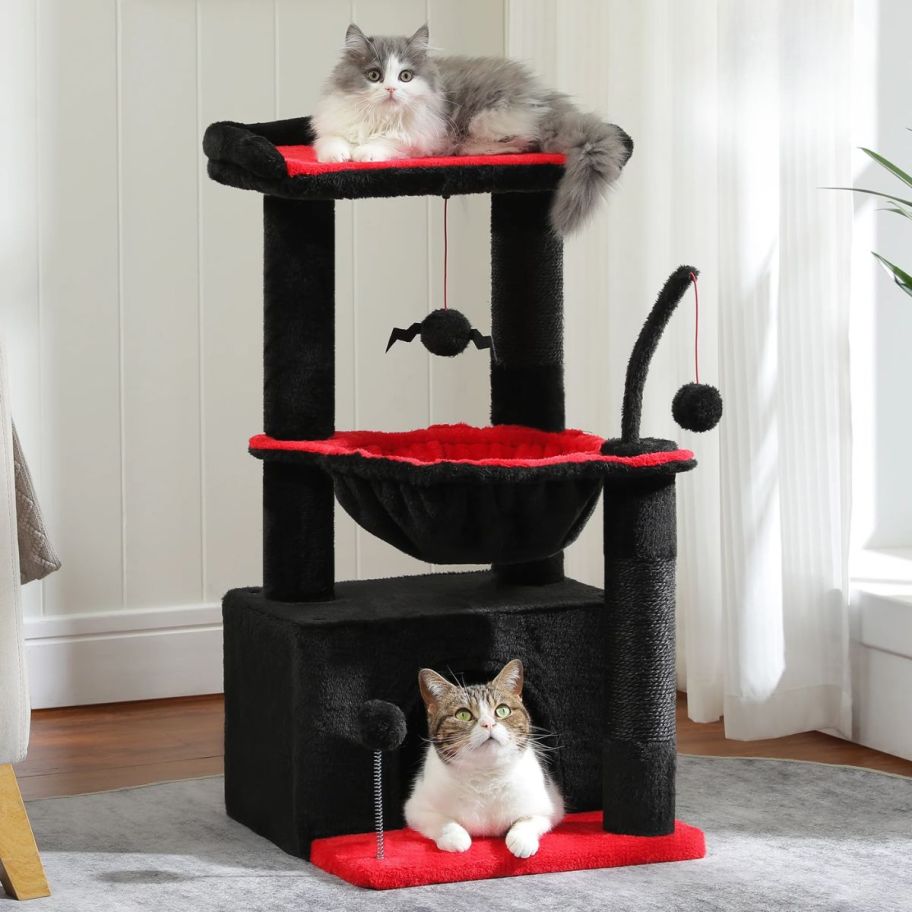 gothic themed cat tree with 2 cats on it