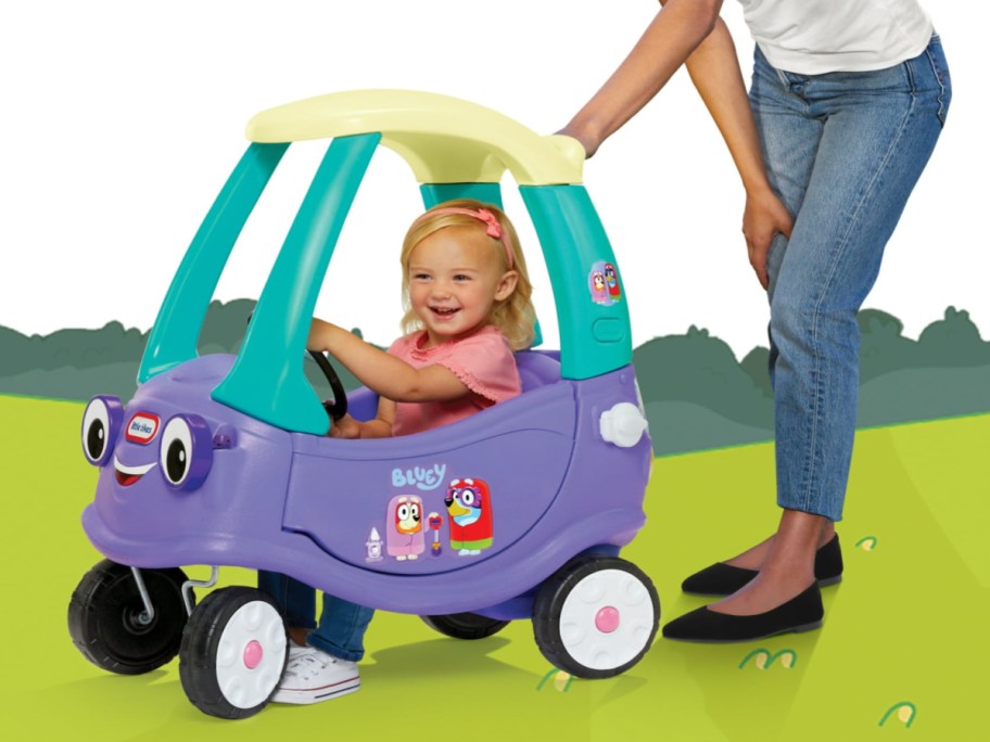 little girl in a little tikes bluey grannie's car coupe being pushed by a woman