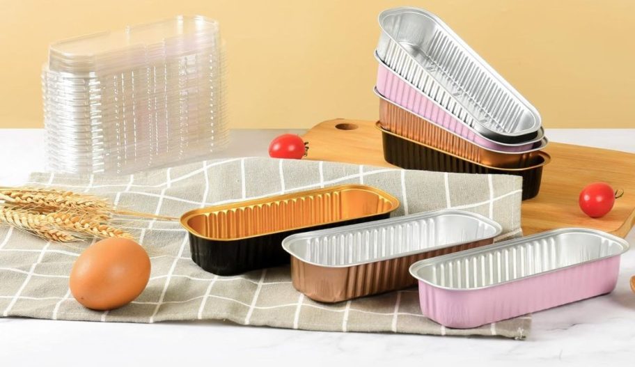 mini loaf pans on counter with lids and ingredients around them