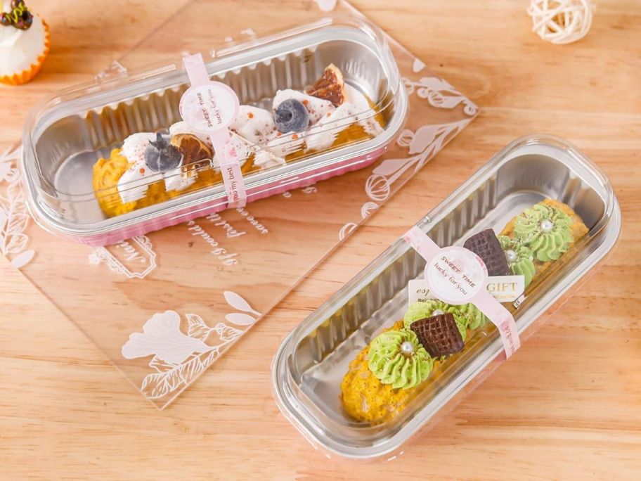 two mini loaf pans with cakes in them on counter