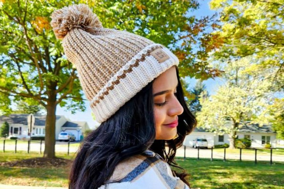side view of a woman wearing a muk luks beanie