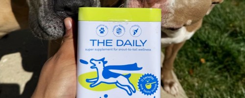 can of Native Pet The Daily supplement being smelled by two dogs